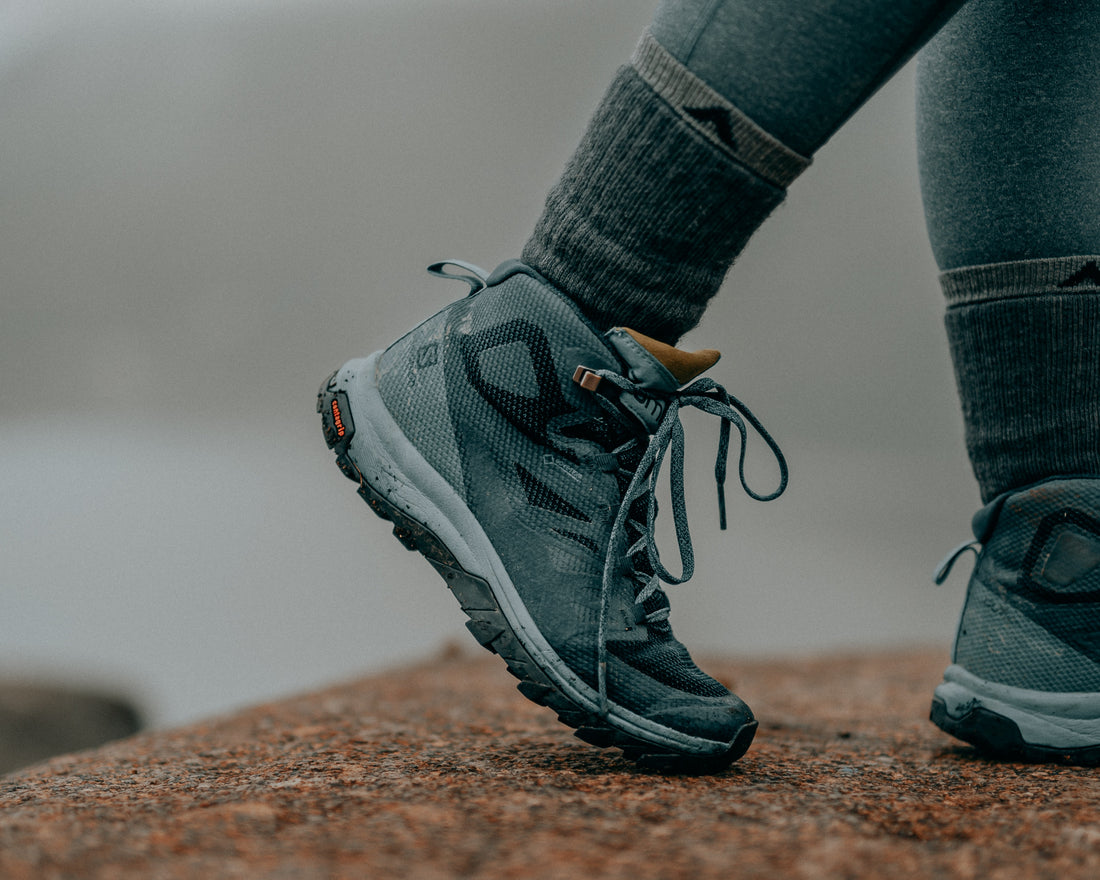 Blue-Green, high-cut with gray midsole, blue green lace, and black lining. Hiking footwear.